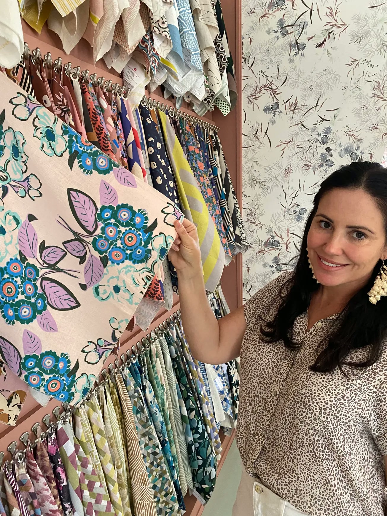Kate of LIV Lilly in the showroom surrounded by colorful fabric swatches